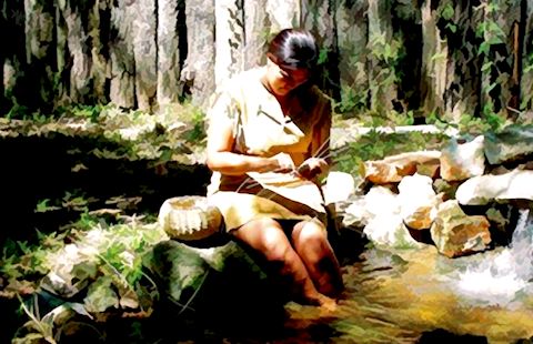 A Cherokee woman weaves a basket.